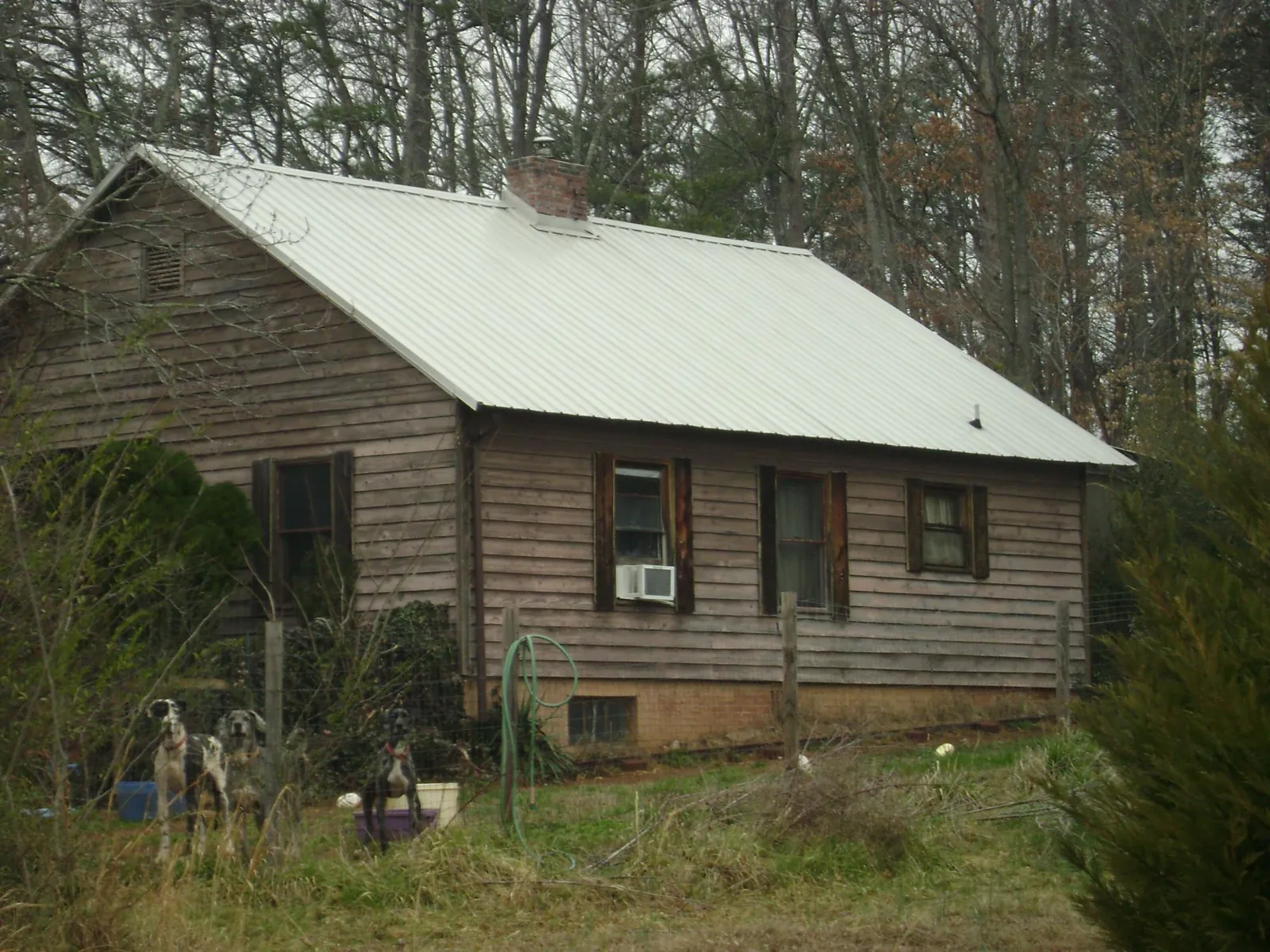 White metal roof on an old wood sided farmhouse, from a Metal Roof Installation job in Elrama